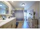 Bathroom featuring large vanity with double sinks, plenty of storage, and shower/tub combo at 1049 Ramsey St, Stanley, NC 28164