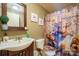 Quaint bathroom featuring vanity with sink, toilet, and shower with custom curtain at 1049 Ramsey St, Stanley, NC 28164