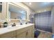 Bathroom featuring double sink vanity with classic framed mirror, and shower with new curtain at 1049 Ramsey St, Stanley, NC 28164