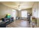 This is a tan bedroom with a wood floor, ceiling fan, and a door leading outside at 1049 Ramsey St, Stanley, NC 28164