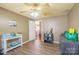 This is a tan bedroom with a wood floor, ceiling fan, and a door leading to another room at 1049 Ramsey St, Stanley, NC 28164