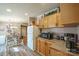 Kitchen with wood cabinets, appliances, and view of the dining area at 1049 Ramsey St, Stanley, NC 28164