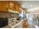 Cozy kitchen with appliances, wood cabinets, and adjacent dining area at 1049 Ramsey St, Stanley, NC 28164