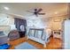 Spacious main bedroom featuring neutral walls, wood flooring, and modern ceiling fan at 1049 Ramsey St, Stanley, NC 28164