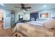 Large main bedroom featuring wood floors, ceiling fan, dresser, and natural light at 1049 Ramsey St, Stanley, NC 28164