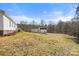 Large, level backyard featuring two storage sheds near the rear property line at 109 Fish Hill Dr, Statesville, NC 28677