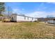 View of the large back yard showing the home, a shed, and mature trees at 109 Fish Hill Dr, Statesville, NC 28677