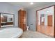 Bathroom featuring a large soaking tub and wood cabinets at 109 Fish Hill Dr, Statesville, NC 28677