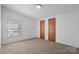 Carpeted bedroom with natural light and two closets at 109 Fish Hill Dr, Statesville, NC 28677