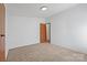 Cozy carpeted bedroom with door to hallway at 109 Fish Hill Dr, Statesville, NC 28677