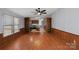 Open-concept dining room flows into kitchen, featuring wood-look flooring, wood accents, and generous natural light at 109 Fish Hill Dr, Statesville, NC 28677