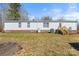 Back of house showing white vinyl siding, brick foundation, gas tank, and back stairs at 109 Fish Hill Dr, Statesville, NC 28677