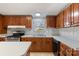Well-lit kitchen features wood cabinets, stainless steel appliances, and a double sink beneath a bright window at 109 Fish Hill Dr, Statesville, NC 28677