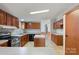 Bright kitchen with ample wood cabinetry, stainless steel range, and a convenient center island at 109 Fish Hill Dr, Statesville, NC 28677