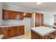 Functional kitchen features ample wood cabinetry, a practical island, and efficient layout at 109 Fish Hill Dr, Statesville, NC 28677