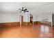 Large living room with a ceiling fan, wood-look floors, and access to other rooms at 109 Fish Hill Dr, Statesville, NC 28677