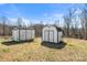 Two white storage sheds in backyard provides ample space for outdoor equipment storage at 109 Fish Hill Dr, Statesville, NC 28677