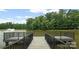 Dock overlooking a scenic lake, offering a serene view of the surrounding trees at 1116 Crooked River Dr, Waxhaw, NC 28173