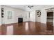 Open living room featuring a fireplace, hardwood floors, large windows and recessed lighting at 1189 Sandy Bottom Nw Dr, Concord, NC 28027