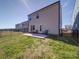 A fenced backyard features a concrete patio, a grassy lawn, and an exterior view of a multi-story home at 1232 Scotch Meadows Loop, Monroe, NC 28110