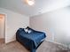 Neutral bedroom with plush carpet, a ceiling light, and a cozy bed with decorative pillows and comforter at 1232 Scotch Meadows Loop, Monroe, NC 28110