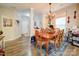 This dining room features a wooden table, six chairs, a unique chandelier, and natural light at 1232 Scotch Meadows Loop, Monroe, NC 28110