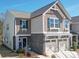 Charming two-story home features a two-car garage, stone accents, and a welcoming entrance at 1232 Scotch Meadows Loop, Monroe, NC 28110
