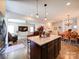 Open-concept kitchen showcasing a large island, modern pendant lighting, and seamless flow into living and dining areas at 1232 Scotch Meadows Loop, Monroe, NC 28110