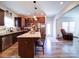 Well-equipped kitchen with stainless steel appliances, dark wood cabinetry, granite countertops, and a center island with seating at 1232 Scotch Meadows Loop, Monroe, NC 28110