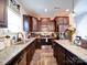 Well-appointed kitchen boasting granite countertops, stainless steel appliances, dark cabinets, and an island with bar seating at 1232 Scotch Meadows Loop, Monroe, NC 28110