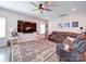 Expansive living room boasts a large sectional sofa, a modern ceiling fan, and a sleek entertainment setup at 1232 Scotch Meadows Loop, Monroe, NC 28110