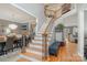 Bright staircase featuring wood treads, iron balusters, with dining and living rooms visible at 12441 Morning Creek Ln, Charlotte, NC 28214