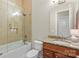 Clean bathroom with a shower over tub, granite countertop, and a wood vanity at 133 Crooked Branch Way, Troutman, NC 28166