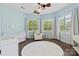 Bright Bedroom with a ceiling fan, large windows, a white crib, and a cozy chair at 133 Crooked Branch Way, Troutman, NC 28166
