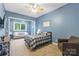 Comfortable bedroom featuring a cozy bed and a seating area with bright natural light at 133 Crooked Branch Way, Troutman, NC 28166