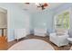 Serene Bedroom with a white crib, dresser, chair, and soft natural light at 133 Crooked Branch Way, Troutman, NC 28166