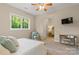 Comfortable bedroom with a seating area, soft carpet, and a view of nature at 133 Crooked Branch Way, Troutman, NC 28166