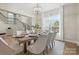 Elegant dining room with ample seating, natural light, and hardwood floors at 133 Crooked Branch Way, Troutman, NC 28166