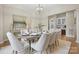 Formal dining room featuring a large table, elegant lighting, and sophisticated decor at 133 Crooked Branch Way, Troutman, NC 28166