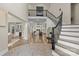 Elegant foyer with a winding staircase that shows the bright, airy open floor plan at 133 Crooked Branch Way, Troutman, NC 28166