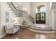 Grand foyer with a striking staircase, wood floors, and an abundance of natural light at 133 Crooked Branch Way, Troutman, NC 28166