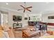 Inviting living room featuring a ceiling fan, hardwood floors, and an entertainment area at 133 Crooked Branch Way, Troutman, NC 28166