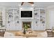 Cozy living room with custom built-ins, a fireplace, and comfortable seating at 133 Crooked Branch Way, Troutman, NC 28166