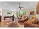 Spacious living room with hardwood floors, ceiling fan, and an area for games and relaxation at 133 Crooked Branch Way, Troutman, NC 28166