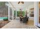A covered patio with a dining table, outdoor kitchen, and views of the pool at 133 Crooked Branch Way, Troutman, NC 28166