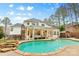 A beautiful backyard with a large pool and patio area, great for outdoor entertaining at 133 Crooked Branch Way, Troutman, NC 28166