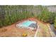 Aerial view of a community pool surrounded by tall pine trees, a perfect outdoor retreat at 133 Crooked Branch Way, Troutman, NC 28166