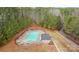 Aerial view of community pool with lounge chairs surrounded by lush trees at 133 Crooked Branch Way, Troutman, NC 28166