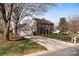 Charming two-story brick home with a well-manicured lawn, inviting curb appeal, and a detached two-car garage at 13717 Strathaven Dr, Matthews, NC 28105