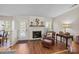 Cozy living room features a fireplace, hardwood floors, and natural light from window at 13717 Strathaven Dr, Matthews, NC 28105